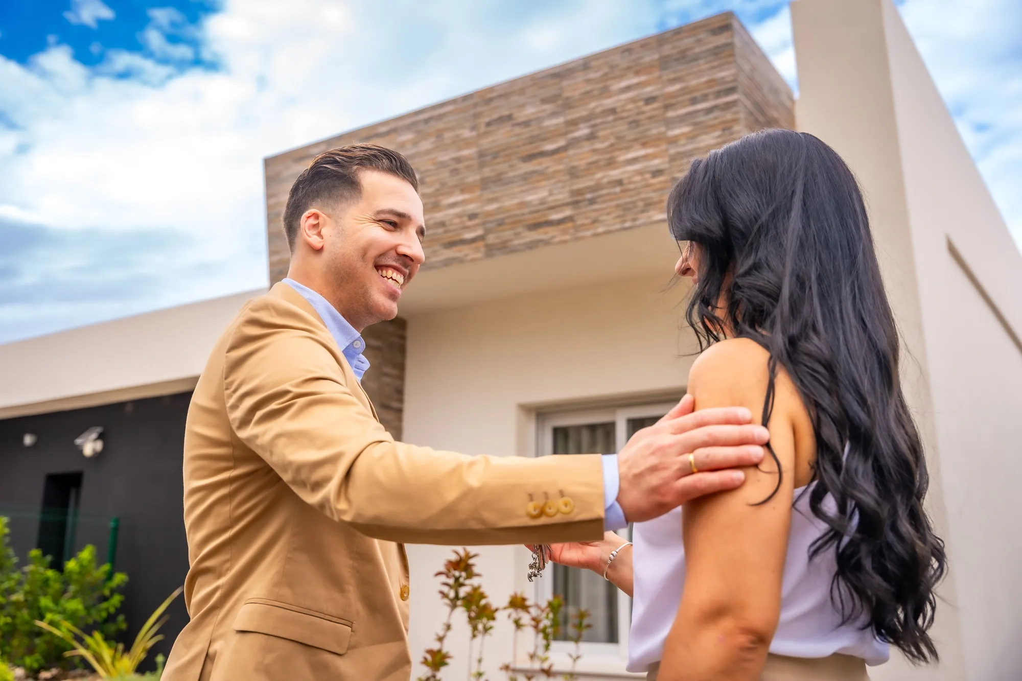 Real state agent congratulating a woman for her new house
